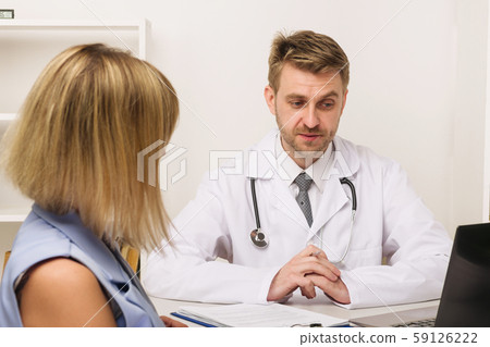 Young woman on a consultation with a male surgeon 59126222