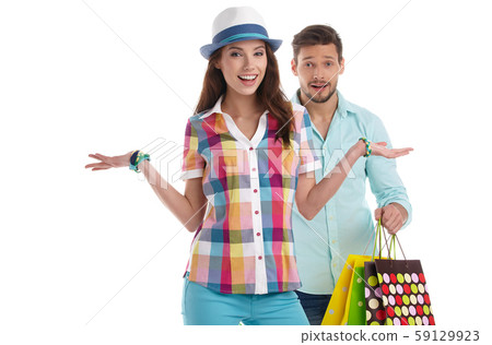 Attractive young couple holding shopping bags on 59129923