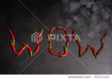 Bright red chilli pepper on a grey concrete background Bright red chilli pepper on a grey concrete background 59131123