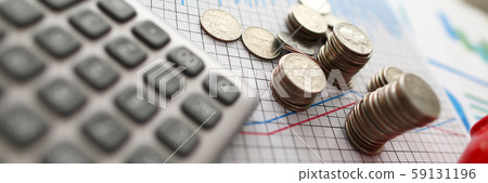 Silver coin tower against business chart background Silver coin tower against business chart background 59131196