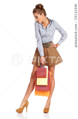 Shopping woman holding bags, isolated on white Shopping woman holding bags, isolated on white 59132446