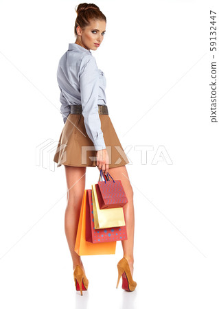 Shopping woman holding bags, isolated on white 59132447
