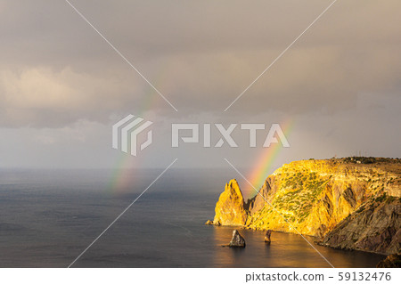 Scenic view from Jasper beach near St. George Monastery to Cape Fiolent in rainy day with rainbow 59132476