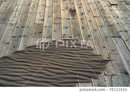Sand on a wooden terrace on the beach 59132810