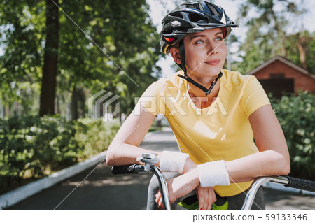 Beautiful smiling woman is riding bicycle outdoors Beautiful smiling woman is riding bicycle outdoors 59133346
