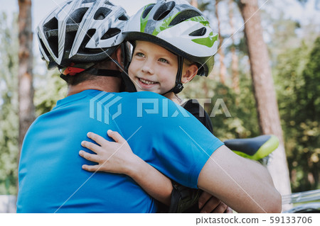 Adorable little girl and her father hugging outdoors 59133706