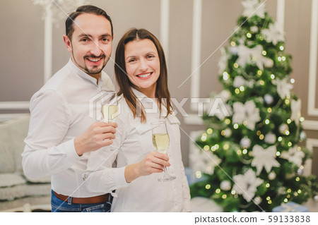 Concept of parties and entertainment. Sweet photo of energetic couple celebrating, with champange in 59133838