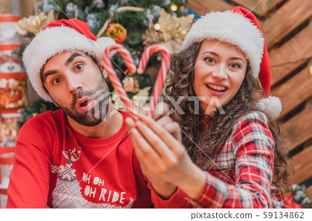 Closeup of cool funny playful and naughty couple make comic grimacexs, fooling around with striped Closeup of cool funny playful and naughty couple make comic grimacexs, fooling around with striped 59134862