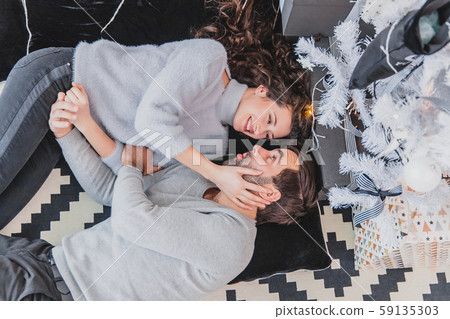 Noel evening and family gathering concept. New Year mood of young people in love. 59135303