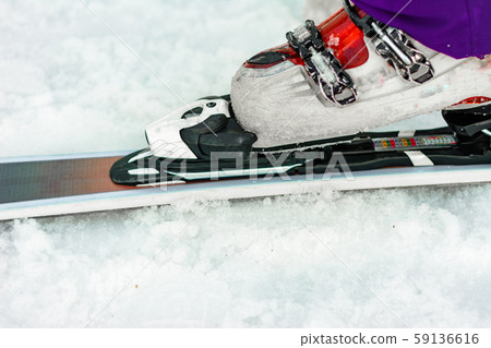 The athlete skier demonstrates a set of skis and The athlete skier demonstrates a set of skis and 59136616