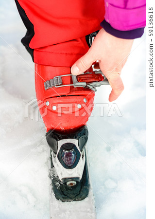 Skier in red ski suit and red ski boots and white Skier in red ski suit and red ski boots and white 59136618
