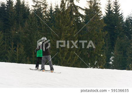 In the Ukrainian Carpathian village, children ski. In the Ukrainian Carpathian village, children ski. 59136635