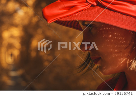Beautiful woman in red autumn dress walks the Beautiful woman in red autumn dress walks the 59136741