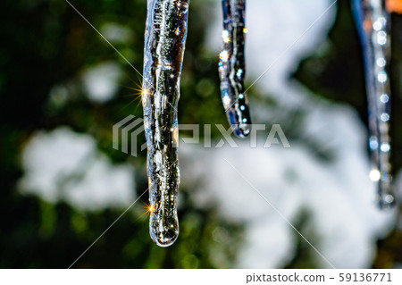 Frozen icicle on the edge of the roof of the house Frozen icicle on the edge of the roof of the house 59136771