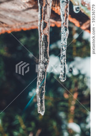Frozen icicle on the edge of the roof of the house Frozen icicle on the edge of the roof of the house 59136779