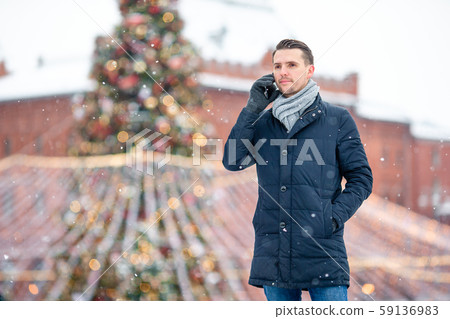 Happy man near fir-tree branch in snow for new year. Happy man near fir-tree branch in snow for new year. 59136983