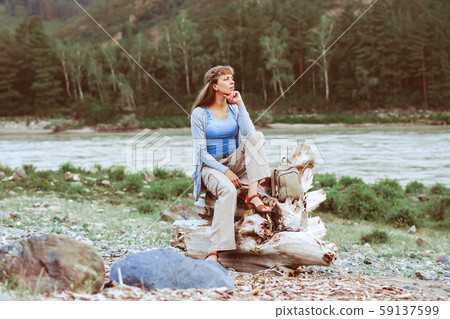 girl sitting by the river 59137599