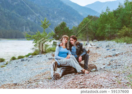 a couple of lovers sitting near the river 59137600