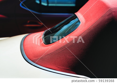 Cabriolet with a red roof in the parking lot 59139168