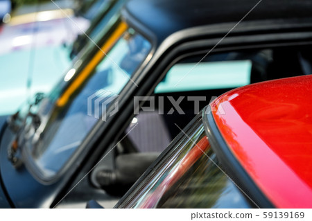 Red and black cars in the parking lot 59139169