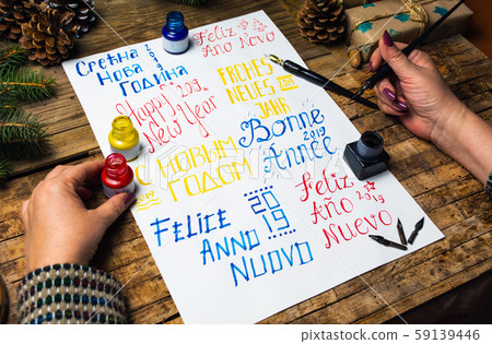 Writing a Happy new year card in various languages 59139446