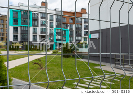 Close-up of metal mesh fencing closed territory of dwelling-house Close-up of metal mesh fencing closed territory of dwelling-house 59140316