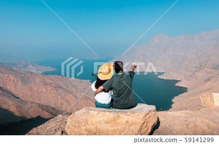 Couple enjoying view of Fjord Khor Najd in Couple enjoying view of Fjord Khor Najd in 59141299