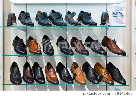 Glass shelves with man's shoes in a shop Glass shelves with man's shoes in a shop 59141463