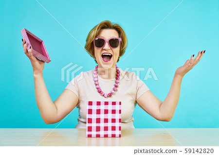Funny excited old woman. A woman in age was very happy to receive gifts. holding opened present box Funny excited old woman. A woman in age was very happy to receive gifts. holding opened present box 59142820