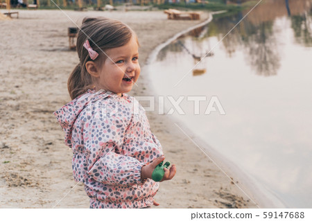 Little adorable girl looking on sunset near river Little adorable girl looking on sunset near river 59147688