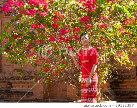 Woman in red dress with red flower asian beauty Myanmar young woman Woman in red dress with red flower asian beauty Myanmar young woman 59152397