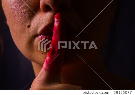 Woman put her finger over her lips 59155077