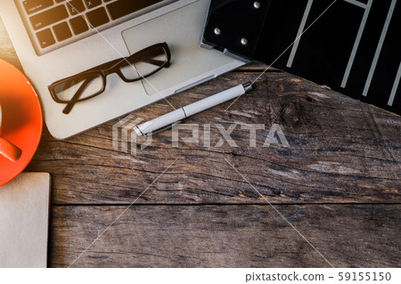 Office accessories laptop, smartphone, notepad, and coffee cup on a wooden table background. View from above. Office accessories laptop, smartphone, notepad, and coffee cup on a wooden table background. View from above. 59155150
