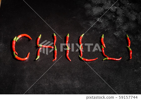 Bright red chilli pepper on a grey concrete background 59157744