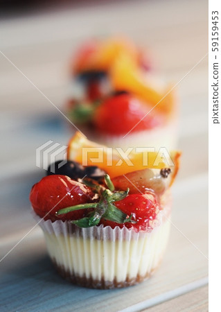 Strawberry cupcakes and green leaves on wooden background Strawberry cupcakes and green leaves on wooden background 59159453