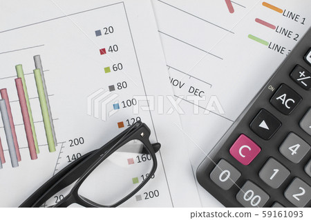 Calculator, and glasses on graph background. Calculator, and glasses on graph background. 59161093