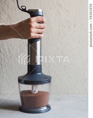Process of grinding cacao beans in a blender. 59161459