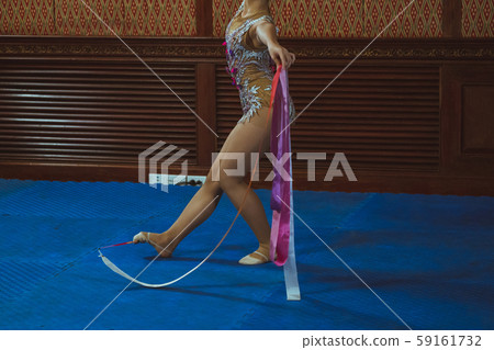 gymnast woman in sportswear dress performing gymnastics 59161732