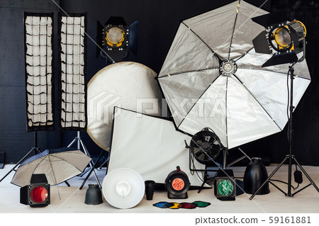Photo studio equipment flash accessories photographer on black background Photo studio equipment flash accessories photographer on black background 59161881