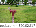 red  fire hydrant sits in a freshly cut grass field. 59162817