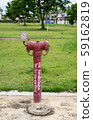 red  fire hydrant sits in a freshly cut grass field. 59162819