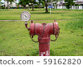 red  fire hydrant sits in a freshly cut grass field. 59162820
