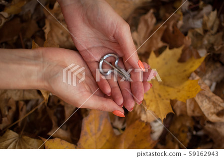 Female hands are holding traditional hutsul drymba or jew's-harp, the oldest musician instrument in Female hands are holding traditional hutsul drymba or jew's-harp, the oldest musician instrument in 59162943