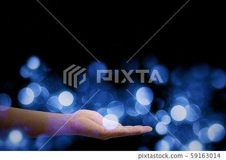 Blue bokeh floating in the palm Blue bokeh floating in the palm 59163014