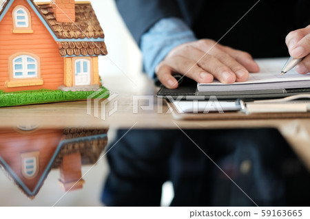 realtor agent working with house model. buying renting real estate property realtor agent working with house model. buying renting real estate property 59163665