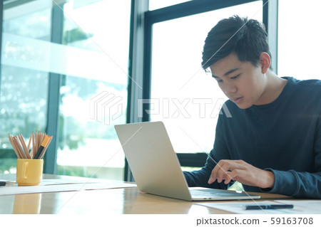 male freelancer working with computer. startup man analyzing financial performance. student studying doing assignment 59163708
