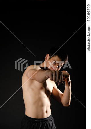 athletic muscular bodybuilder man with naked torso six pack abs boxing punching. fitness workout concept 59164299