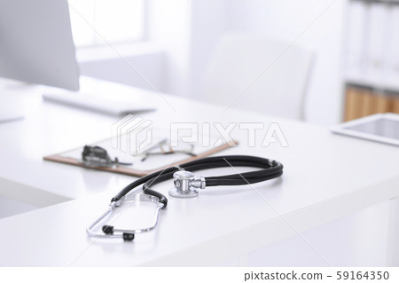 Stethoscope, prescription medical form lying on a table with pc computer. Medicine or pharmacy 59164350