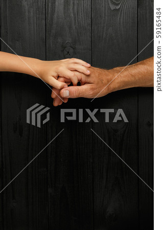 Adult hands holding kid hands Adult hands holding kid hands 59165484