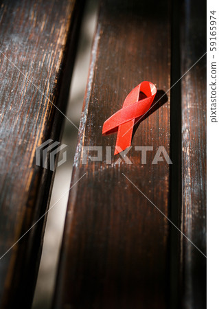 red ribbon on wooden bench, AIDS and HIV ribbon red ribbon on wooden bench, AIDS and HIV ribbon 59165974